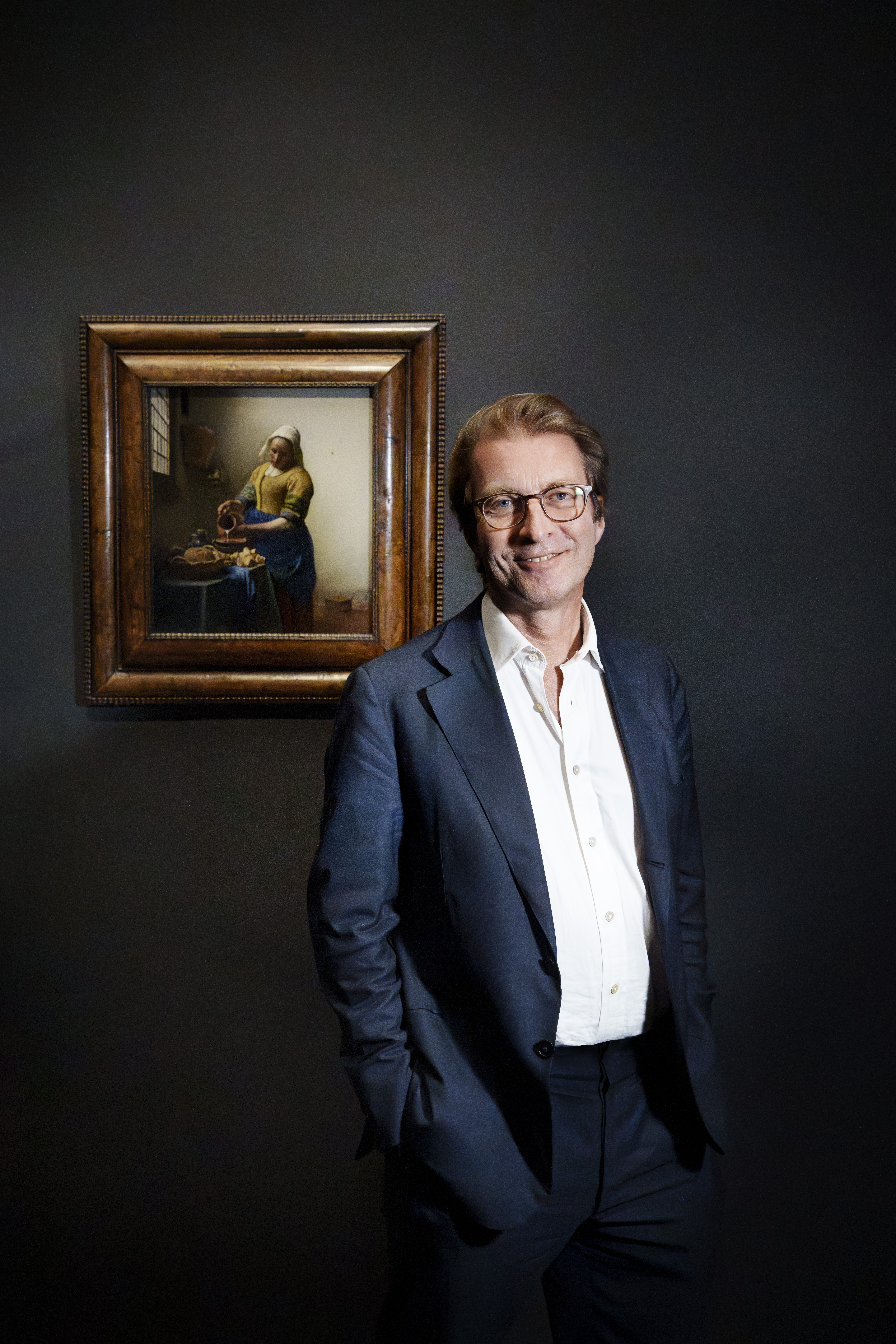 Taco Dibbits, director of the Rijksmuseum, in front of Vermeer's "The Milkmaid" painting.