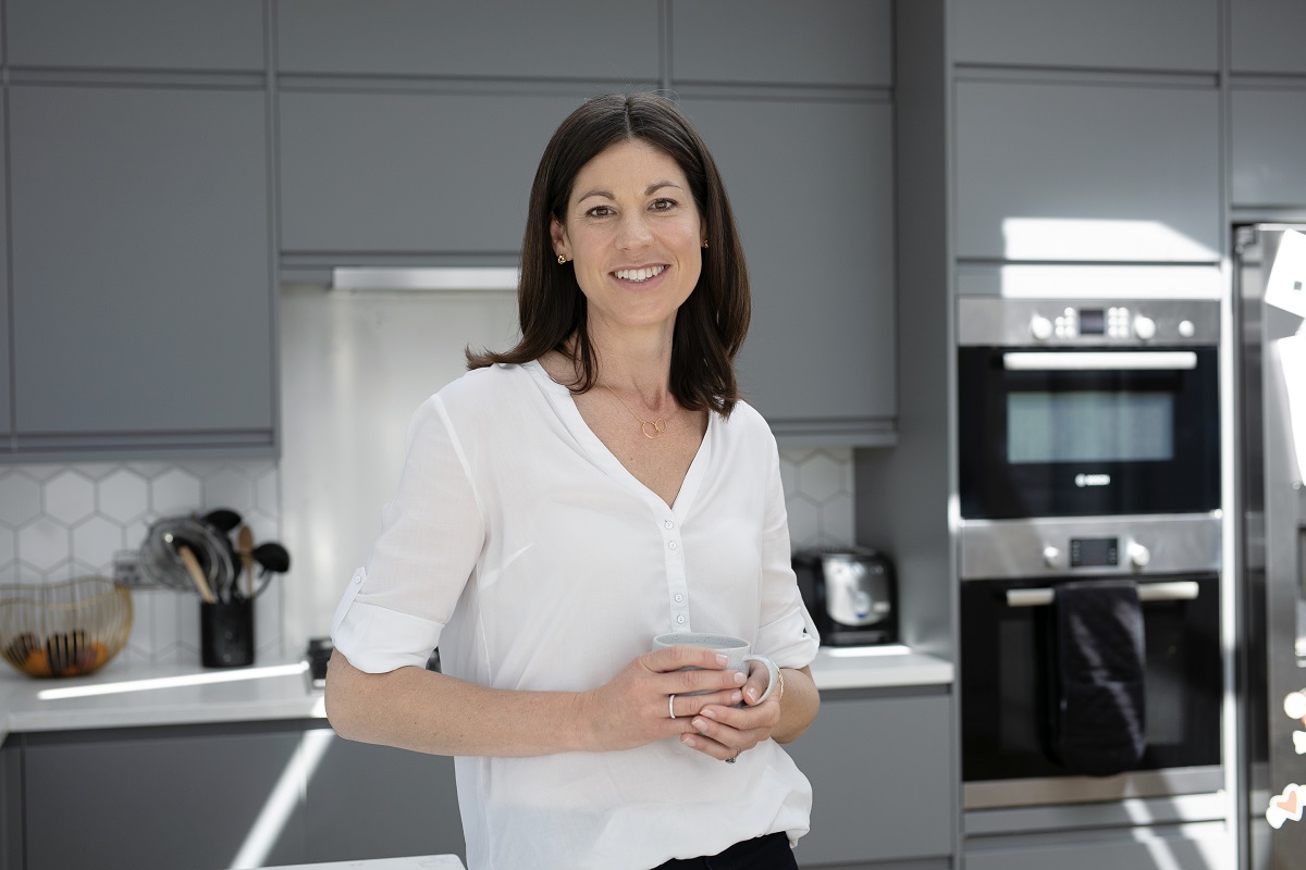 Danielle Peterson, a paediatric dietician, smiling in a kitchen.