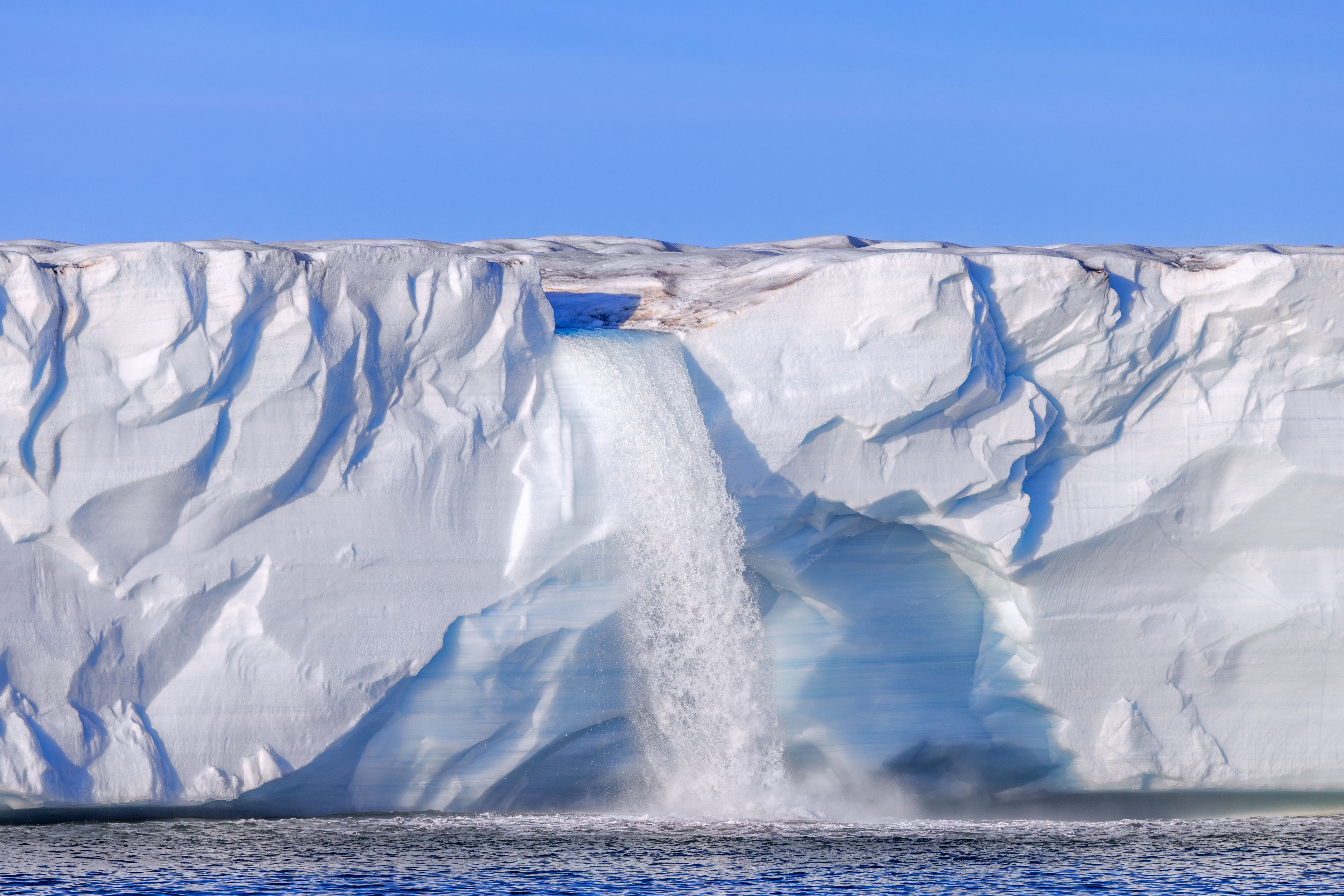 Waterfall at the edge of the Brasvellbreen glacier.