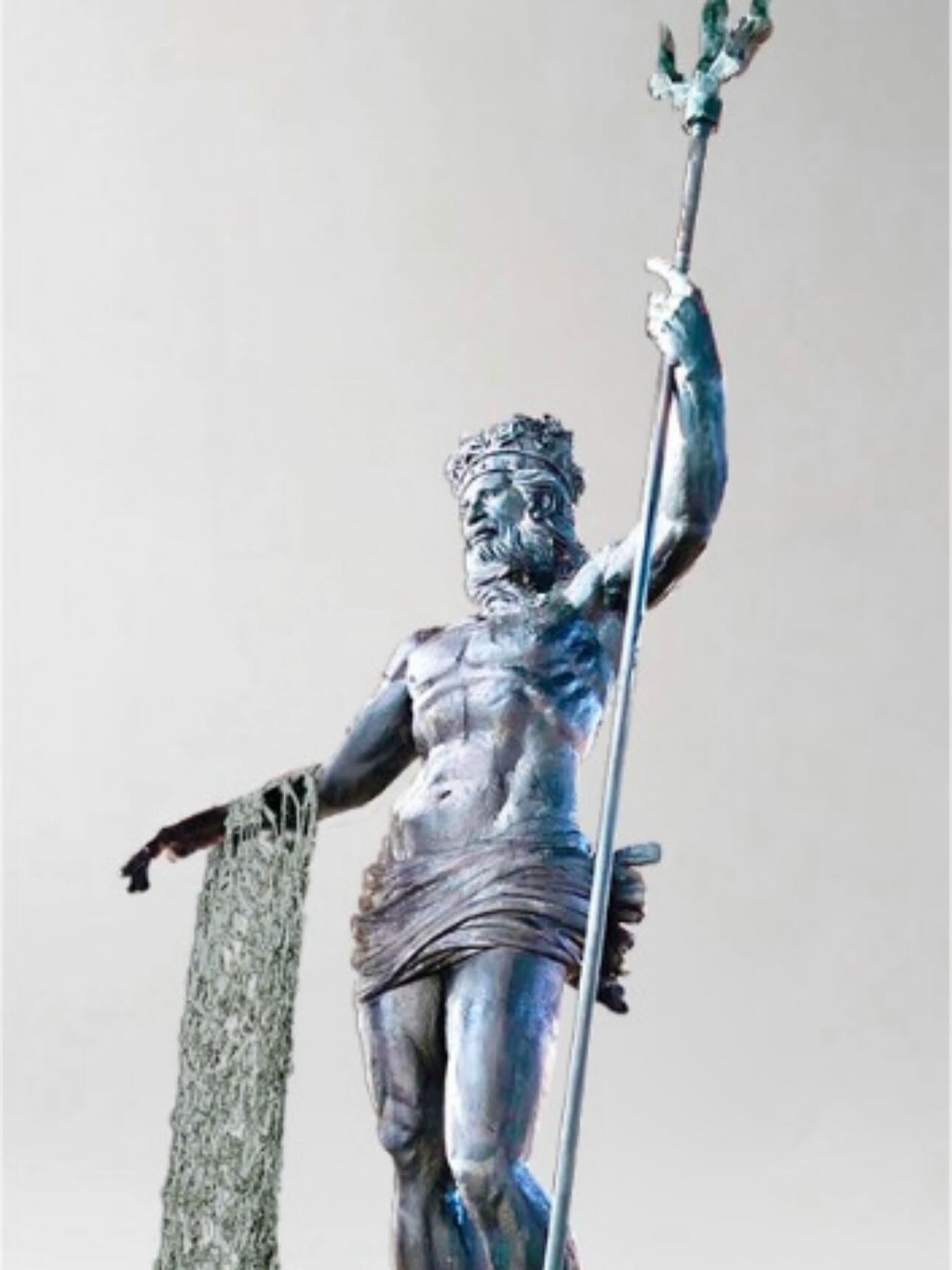 Sculpture by Ginés Serrán-Pagán of Neptune holding a trident and a fishing net.