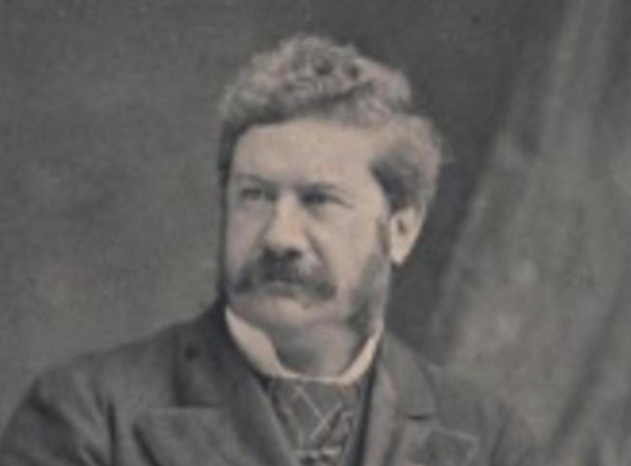 Sir Ashley Eden holding a letter, seated.