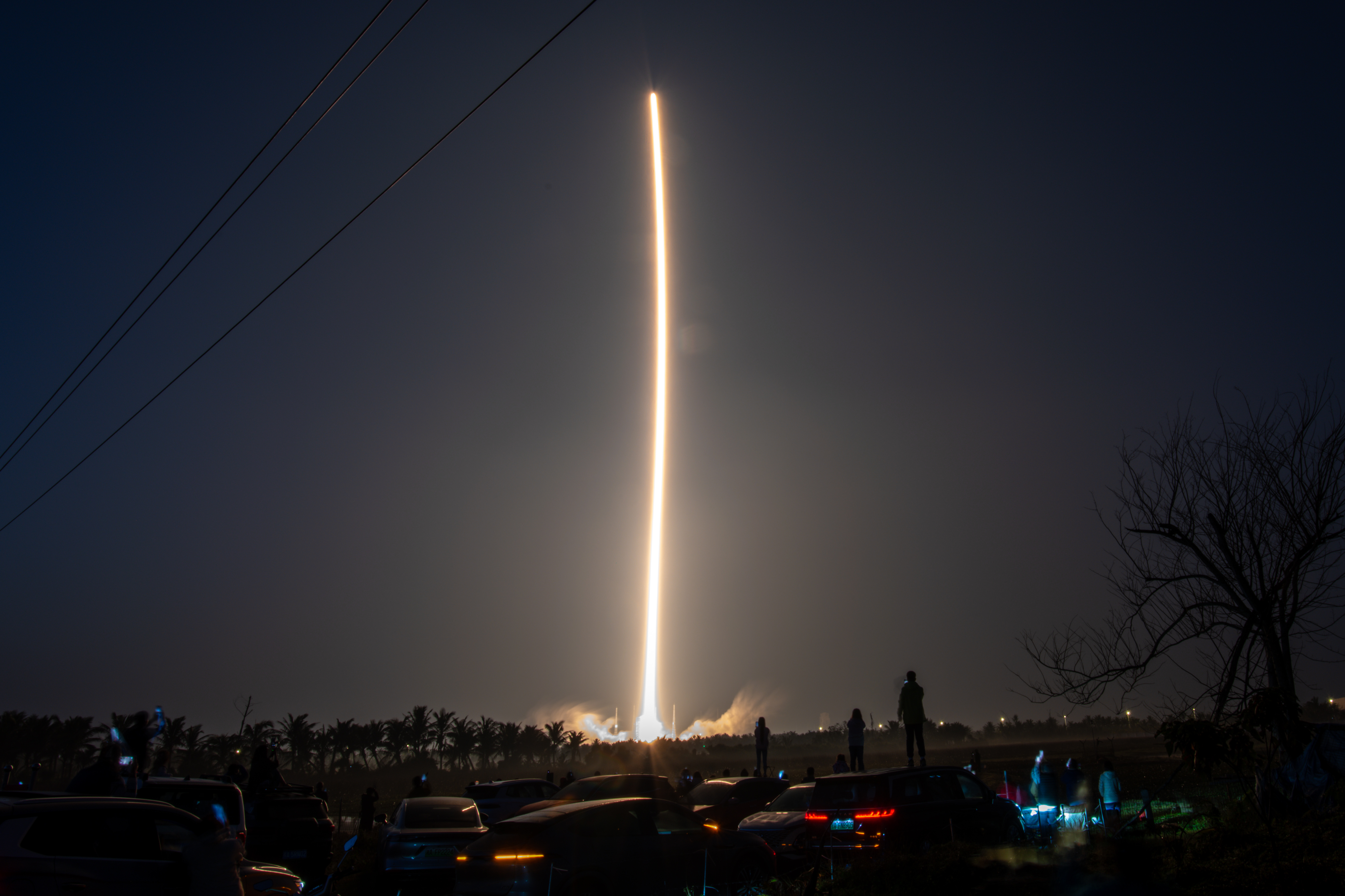A long-exposure image of a Long March-7A carrier rocket launching Shijian-29A and Shijian-29B satellites at night from the Wenchang Space Launch Site.