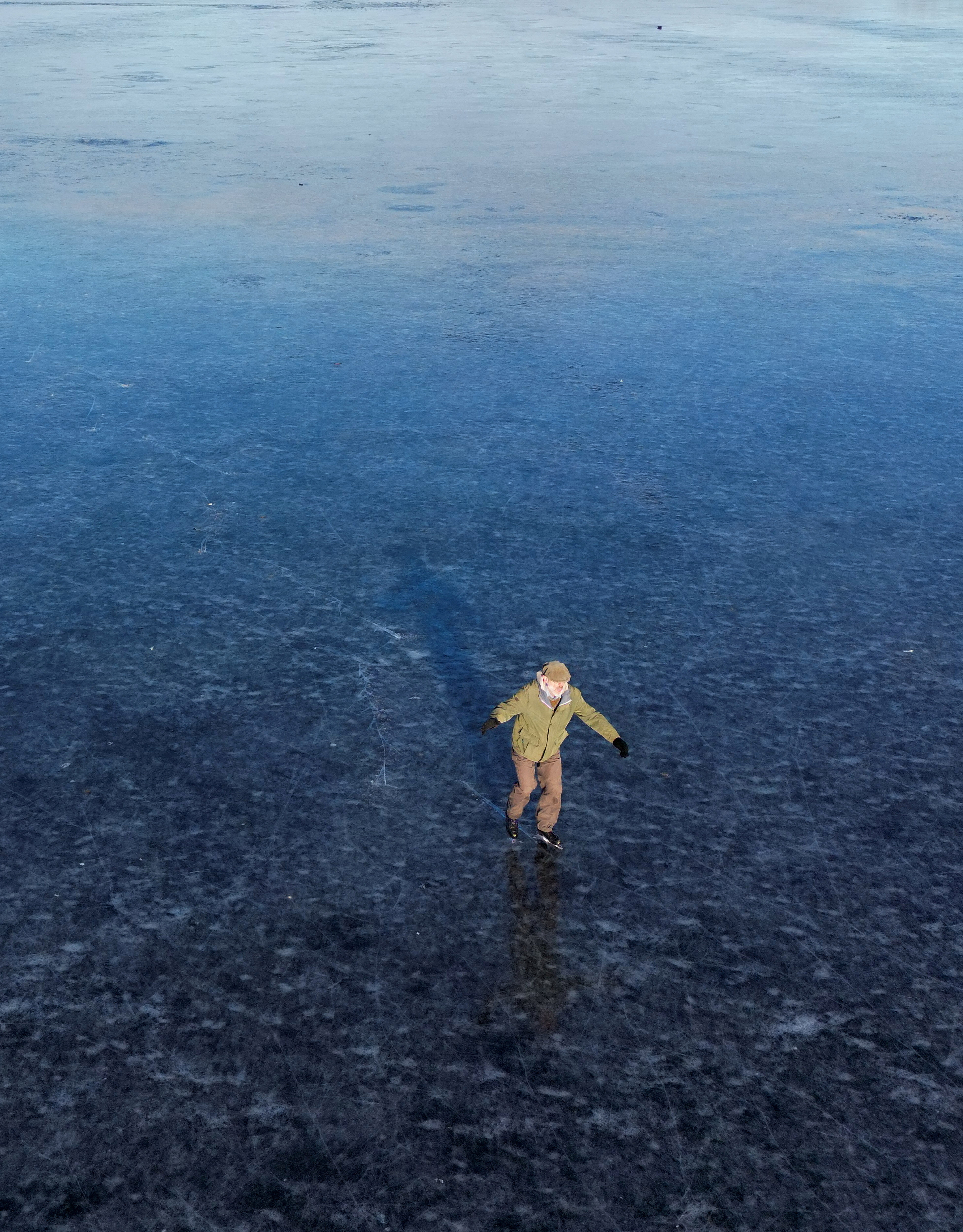 Skaters on frozen flood plain at Port Meadow in Oxford