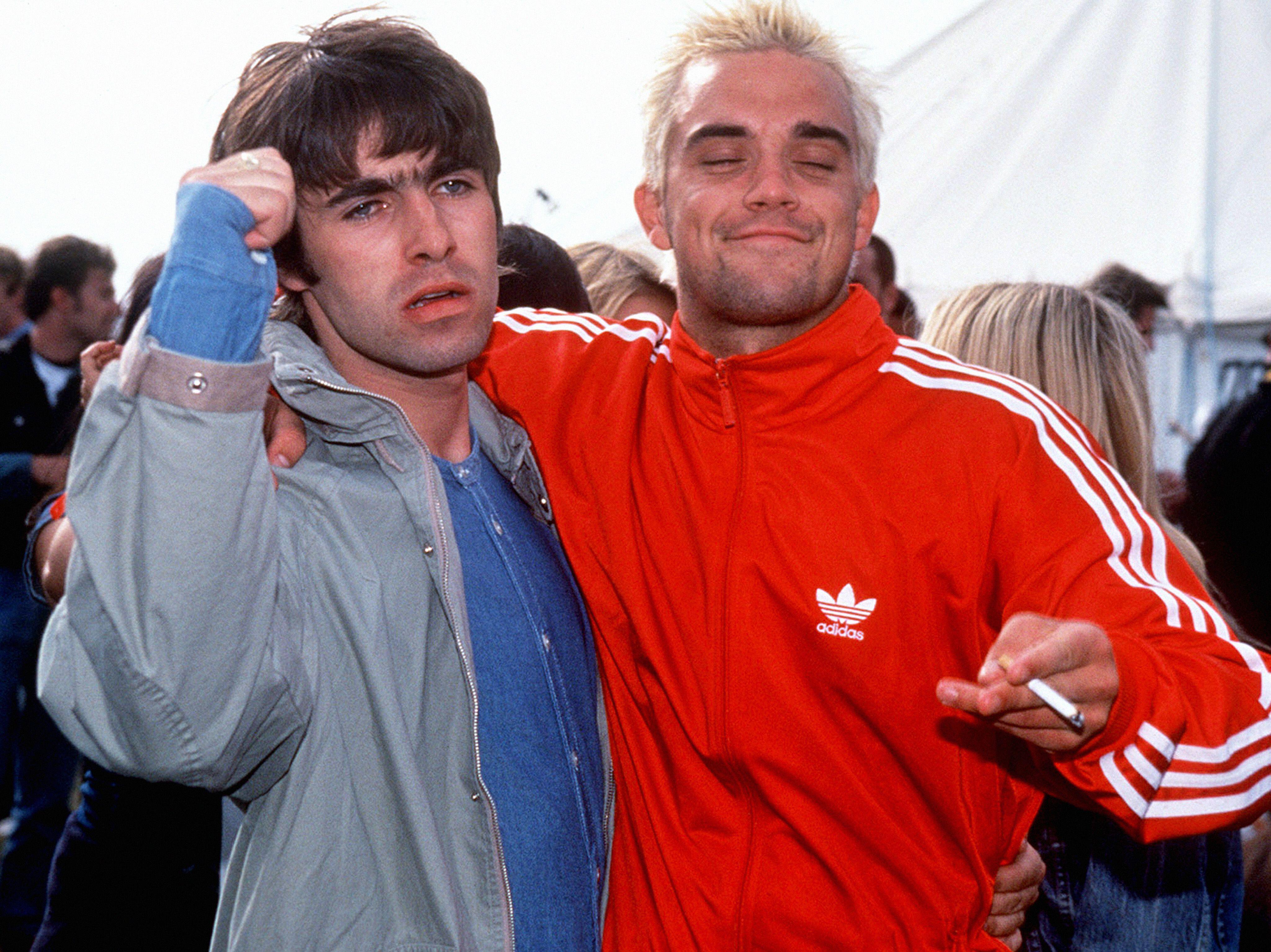 Robbie Williams and Liam Gallagher from Oasis posing together.