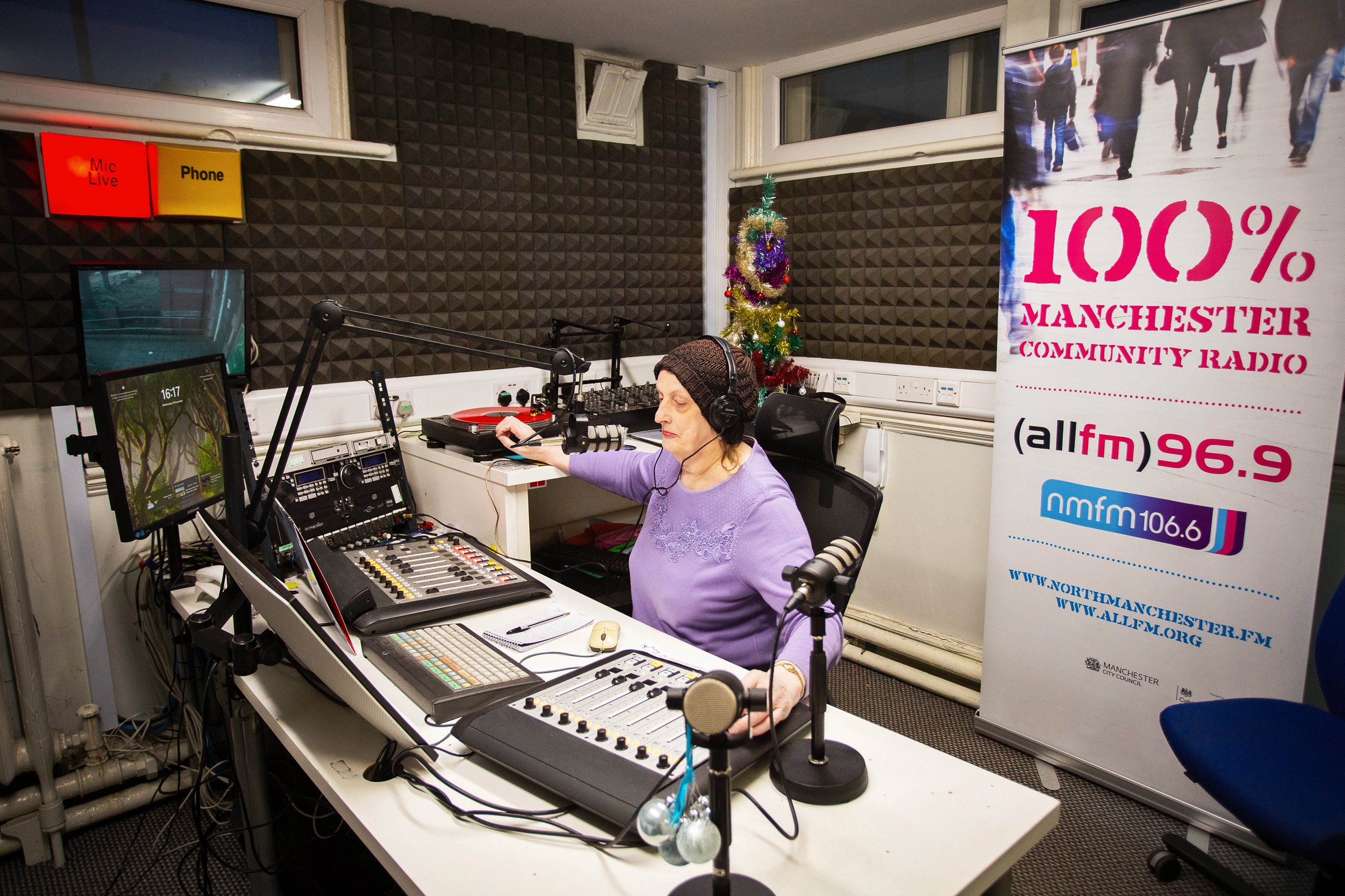 Angharad Denby, a volunteer presenter, broadcasts her show at the All FM community radio station in Manchester.