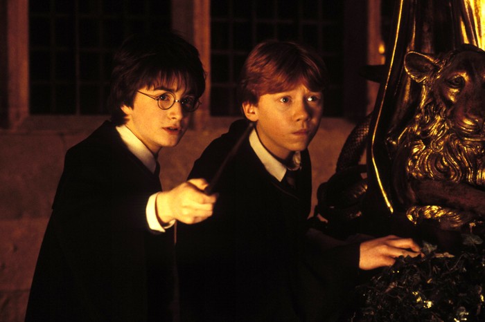 Daniel Radcliffe and Rupert Grint in Harry Potter and the Chamber of Secrets, holding their wands up