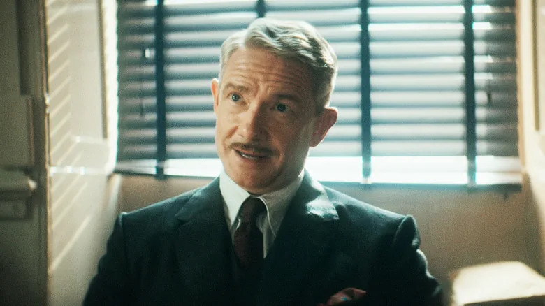 Martin Freeman's Superintendent Battle sits at his desk in Agatha Christie's Seven Dials