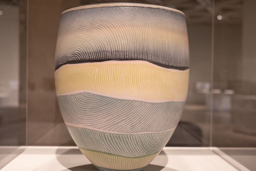 A large porcelain bowl with soft blue tones etched with fine lines