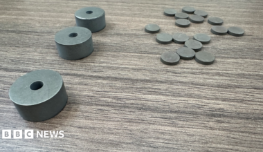 There are three objects on the left and more than a dozen smaller objects shaped like coins on the right.