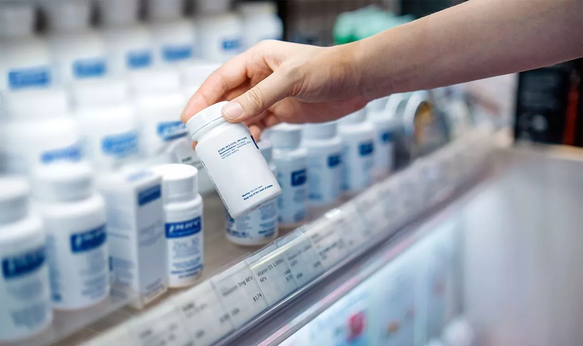 A person picking up a prescription