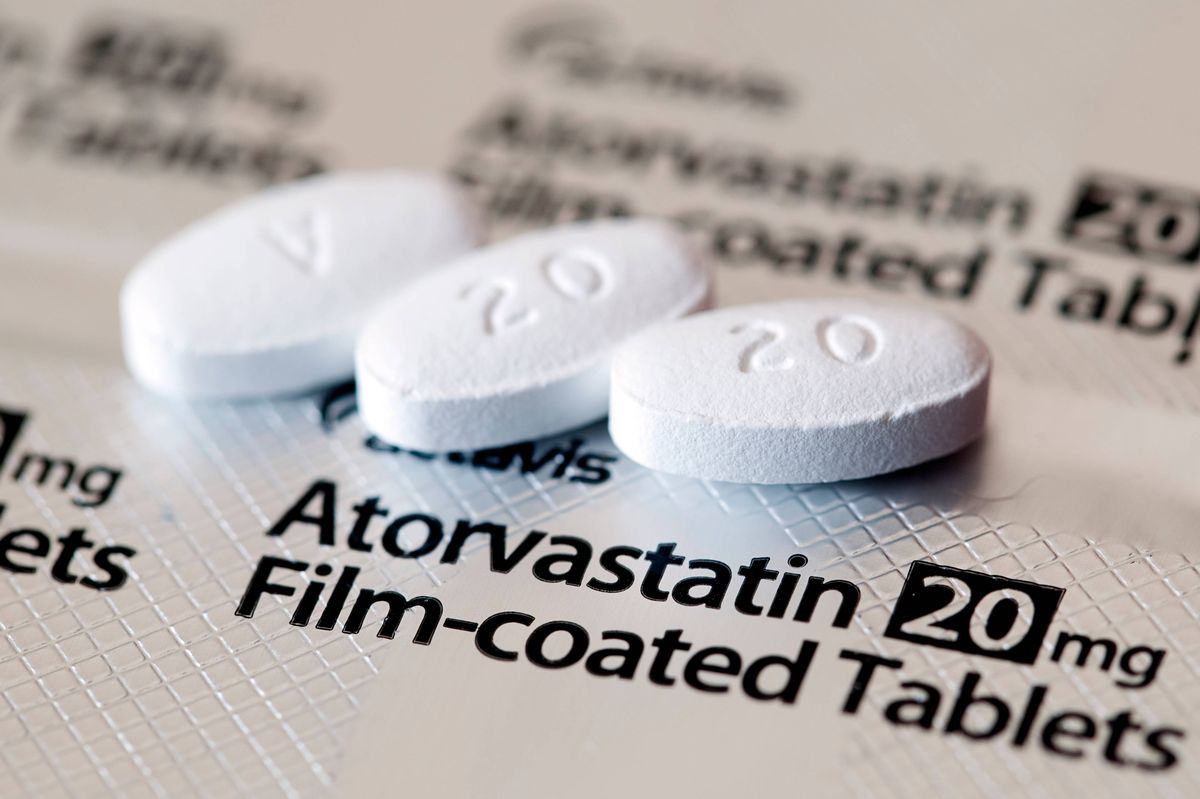 Aberdeen, Scotland - April 7, 2014: Close up view of three Atorvastatin tablets. Atorvastatin is a member of the drug class known as statins, used for lowering blood cholesterol levels.