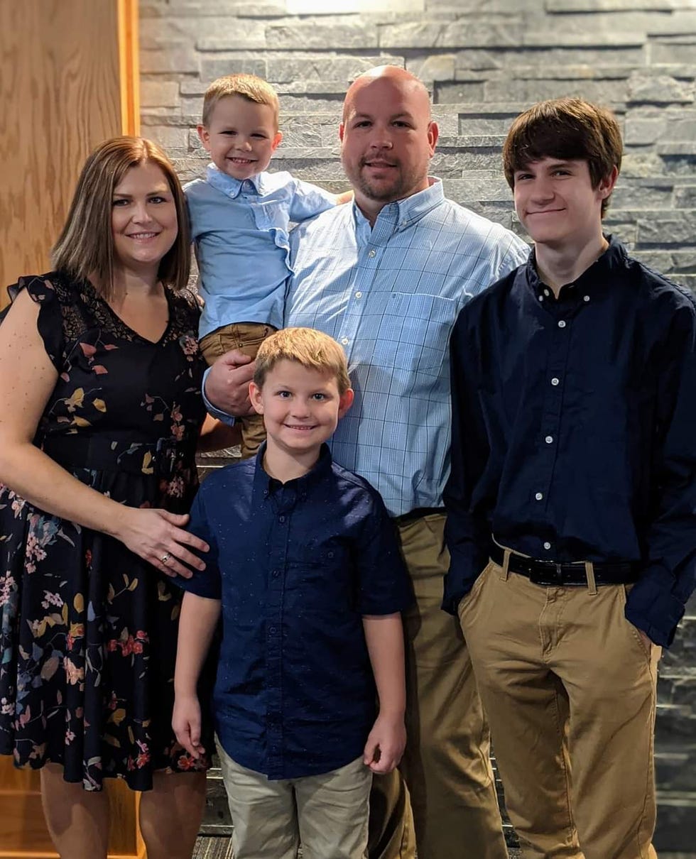 family group portrait with a stone wall background
