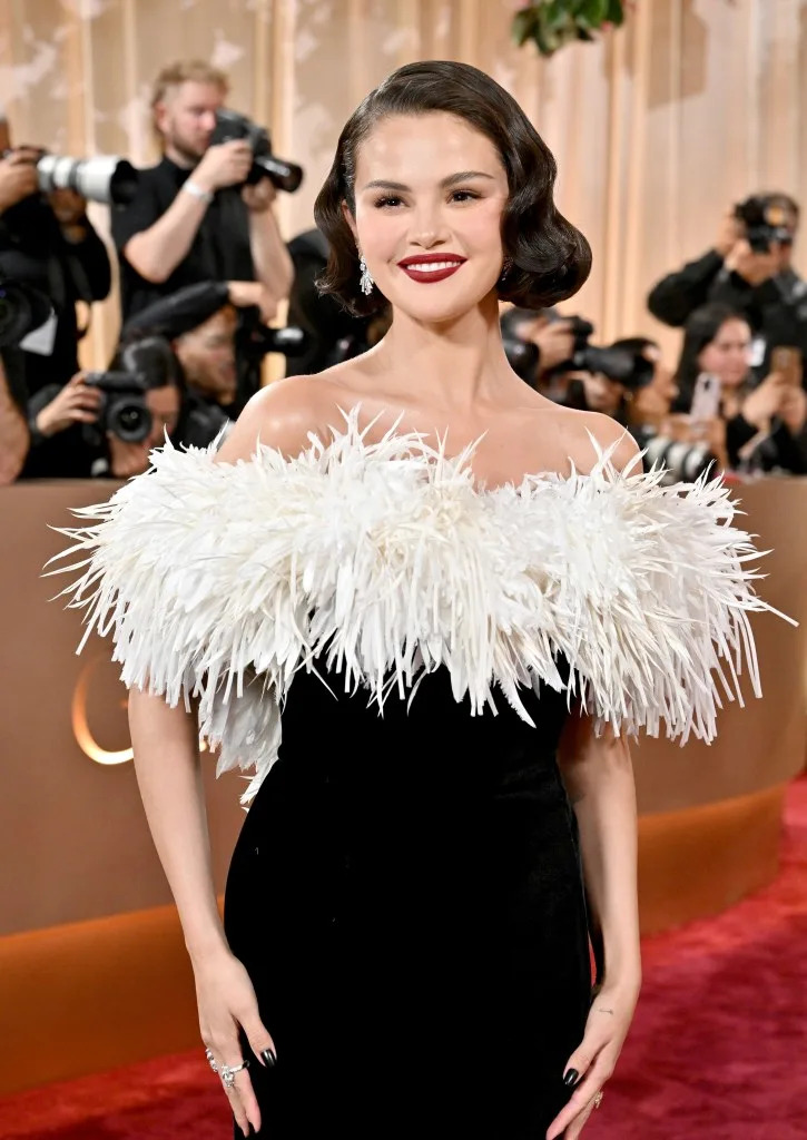 She was photographed wearing brightly colored blush, a bold red lip, and winged eyeliner on the red carpet. FilmMagic