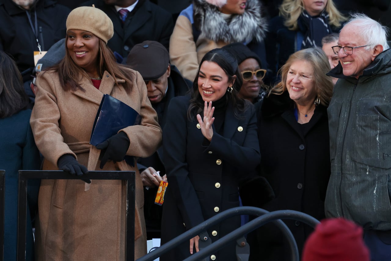 People wave in a crowd.