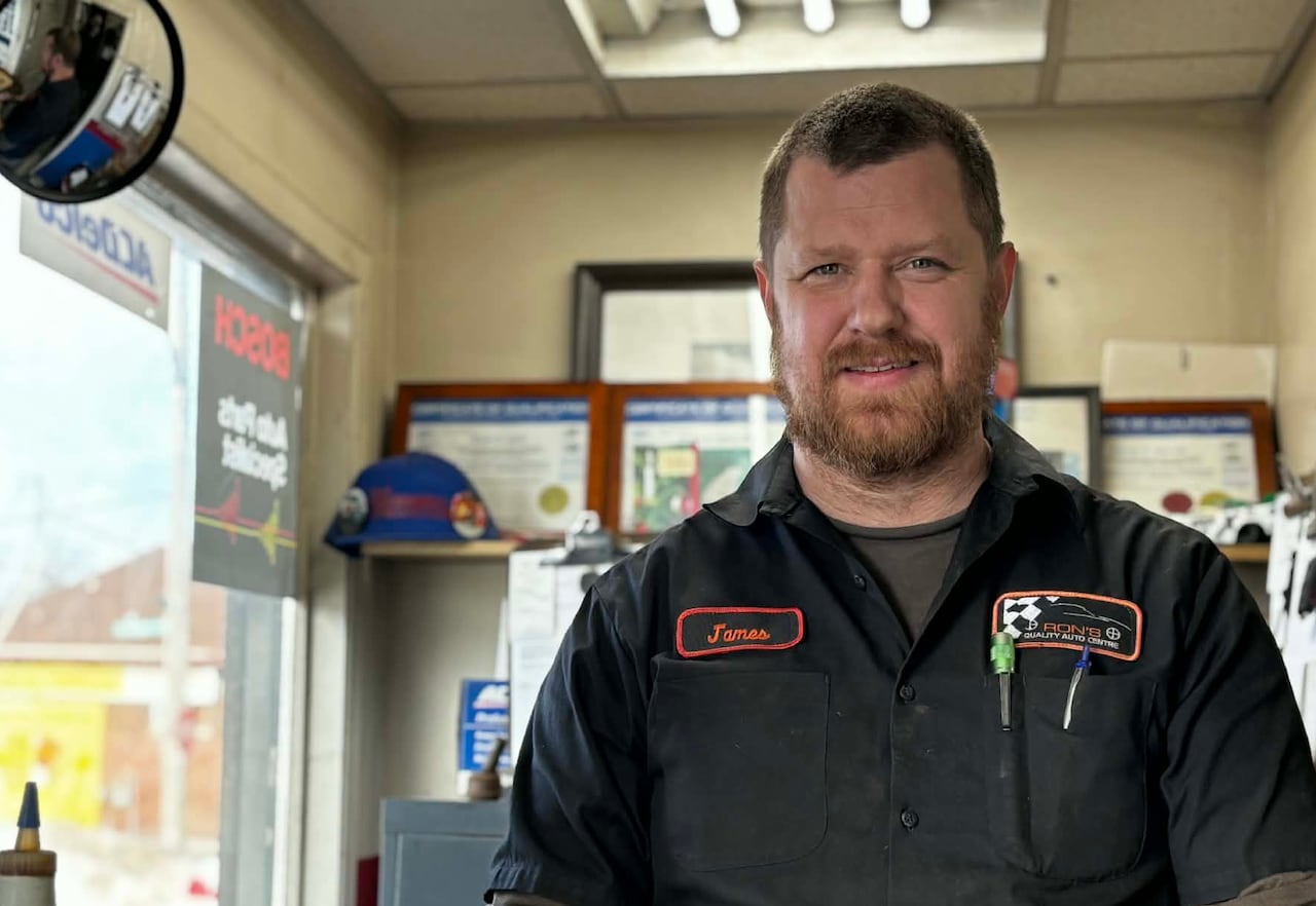 A man in the front office of an auto shop