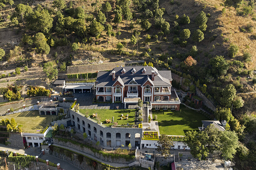 stepped hill house emerges from the terrain in india