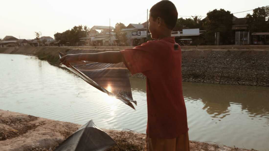 A boy does laundry near the Siem Reap River.