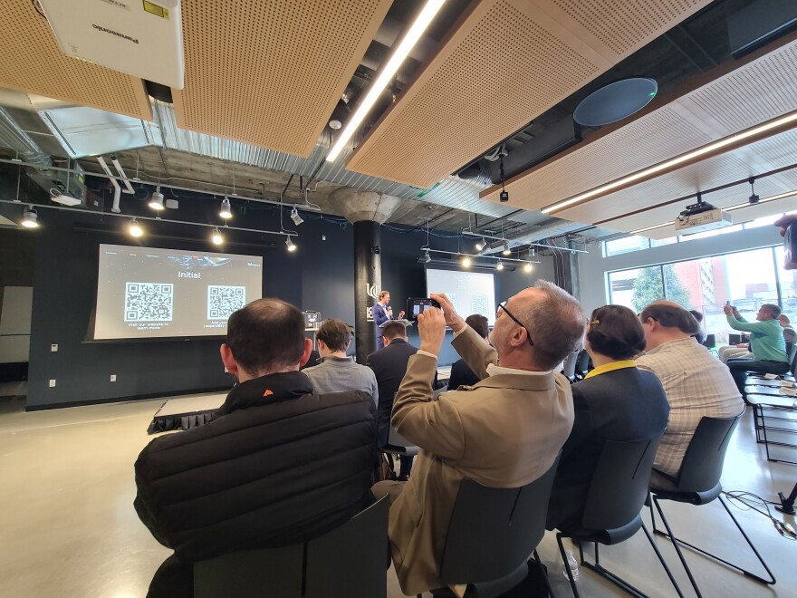 man takes picture of a QR code