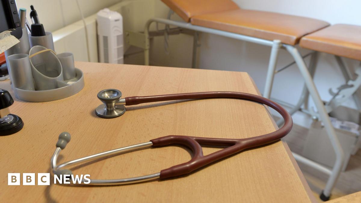A doctors stethoscope on a table in a GP consultation room