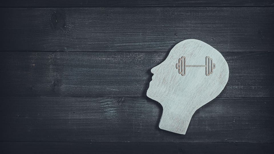 Silhouette of a human head with a barbell inside, symbolizing mental strength and cognitive discipline.