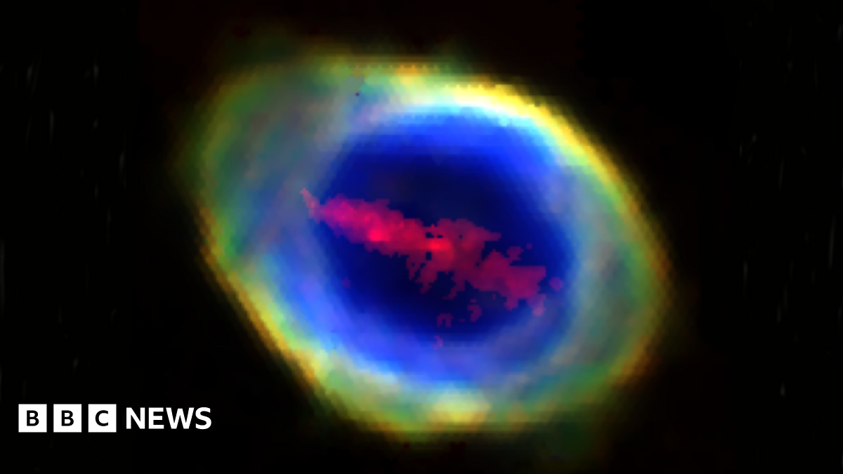 The Ring Nebula in space showing the "red iron bar" in a line across the middle of it.