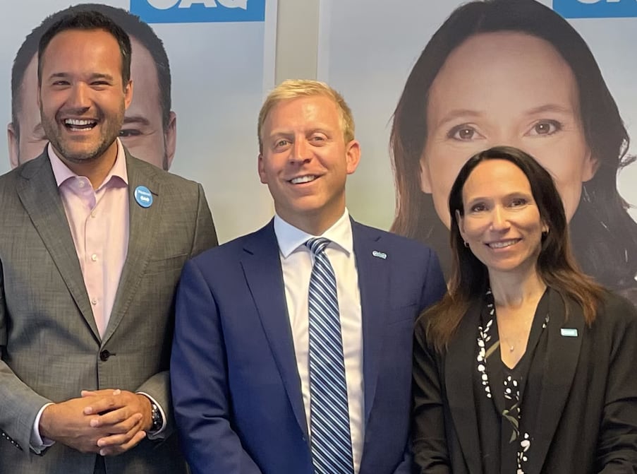 Four politicians smile during a campaign event.