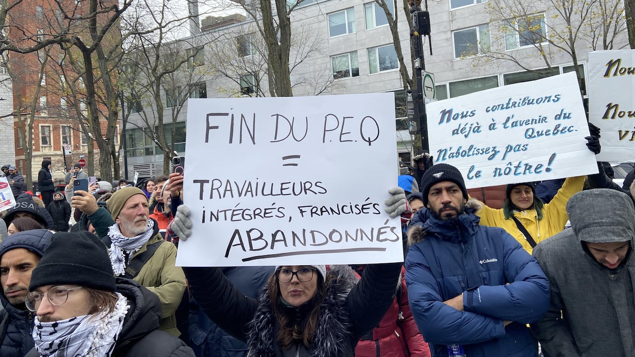 A person holding a sign at a protest.