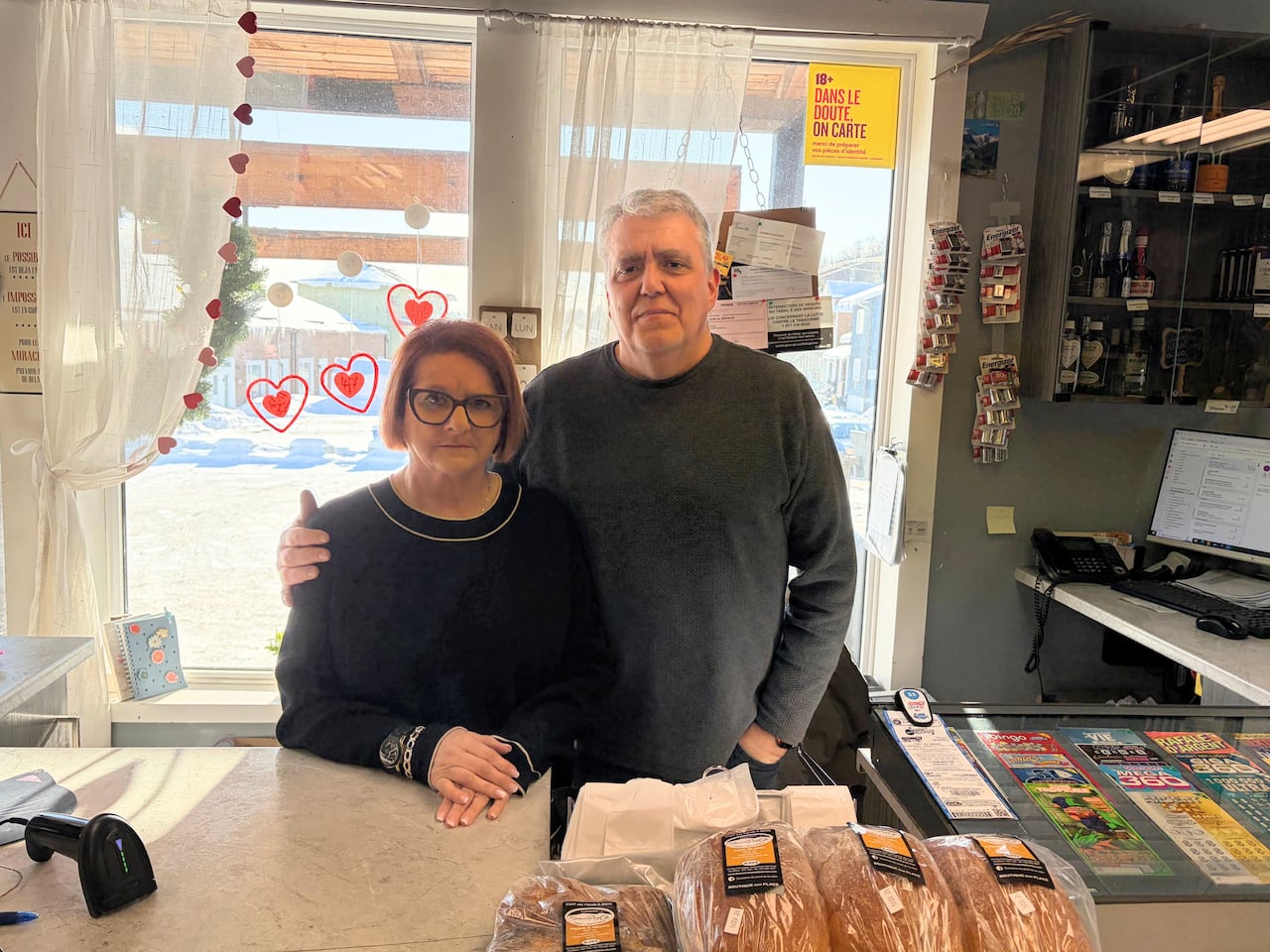 A couple stands behind a counter