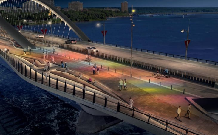 A rendering of a bridge over a river between two cities at night.