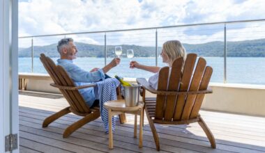 Mature couple drinking wine out on the deck.