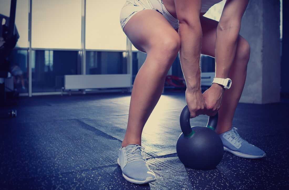 Athletic young woman doing exercises in gym