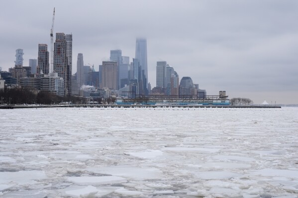 Clouds cover the top of One World Trade, top center, as ice crowds the Hudson River in New York, Monday, Jan. 26, 2026. (AP Photo/Seth Wenig)
