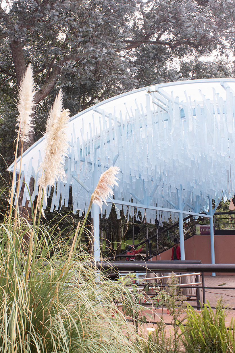 blue fabric fragments dance with the wind on modular cultural pavilion in colombia