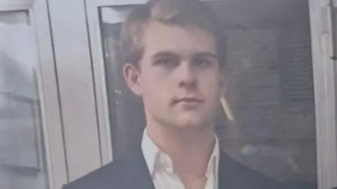 SUPPLIED Achille Osvaldo Giovanni Barosi wears an open-neck shirt and blazer.