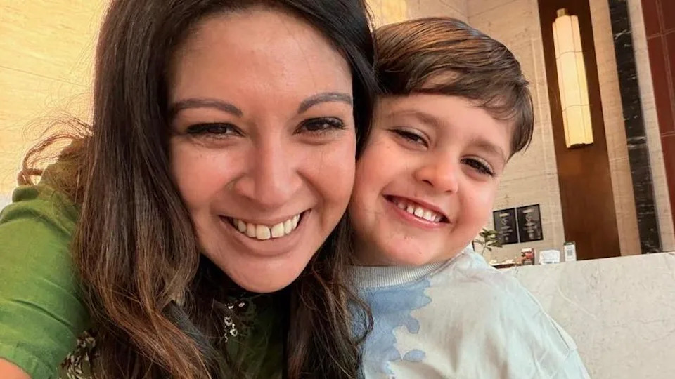 Tiya and her son Arun smiling at the camera