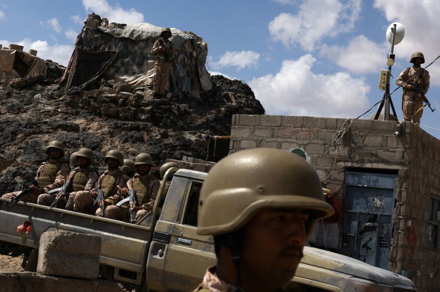 Yemeni soldiers stand guard at a military camp near the frontline with Houthis, in Marib, Yemen, on November 6, 2024.