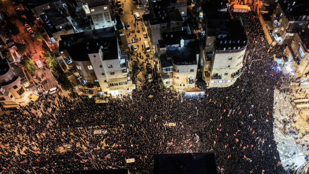A drone view shows Ultra-Orthodox Jewish men as they protest against pressure to conscript men from their community into I...
