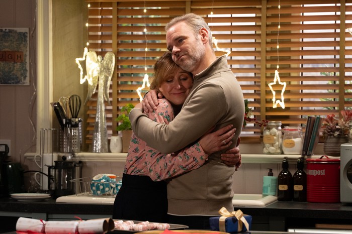 Ray and Laurel hug one another in her kitchen in Emmerdale.