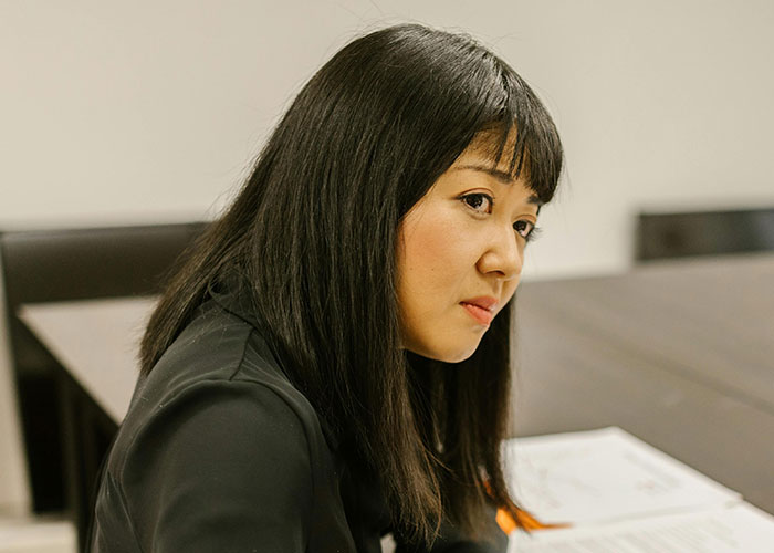 Female doctor looking thoughtful during a patient consultation in a modern medical office setting