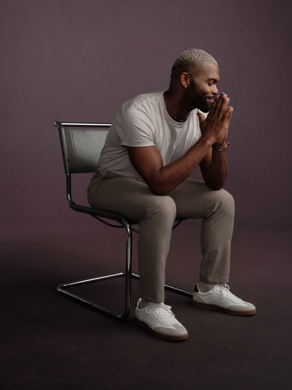a person seated on a modern chair appearing contemplative