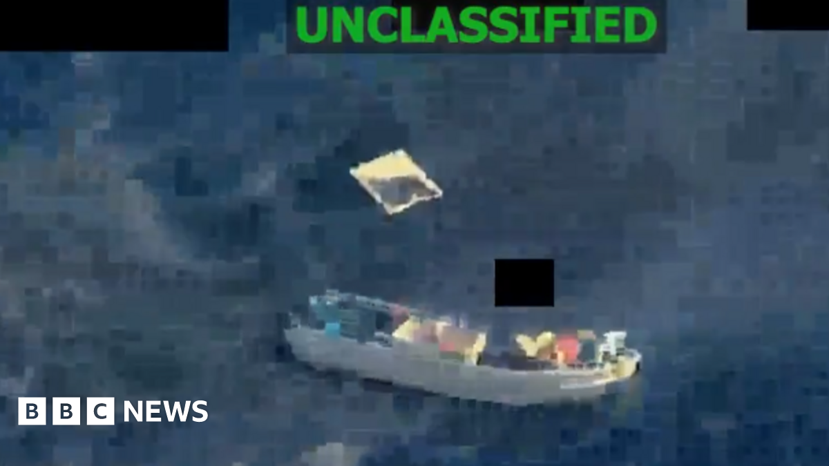 A screengrab from a video posted by US Southern Command shows a small vessel in the sea with what appears to be debris floating nearby. The word "unclassified" has been printed on top of the footage.