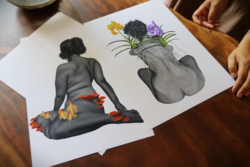 Two self-portrait drawings on a table