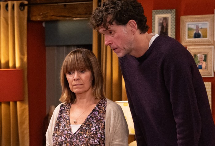 Rhona and Marlon look shocked in a scene from Emmerdale