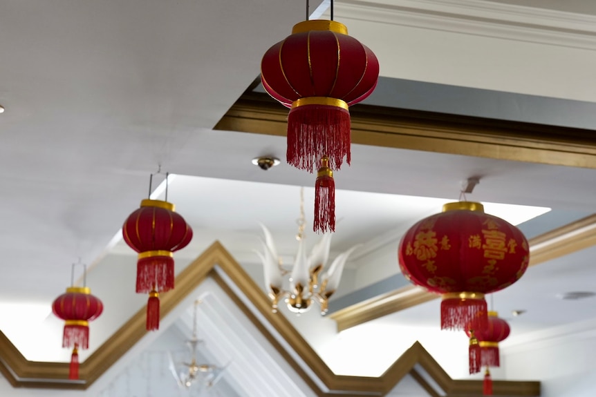Red lights hanging off the ceiling off a restaurant