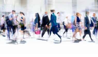 Time-lapse photography of busy pedestrian traffic on a city street.