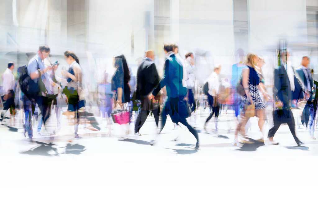 Time-lapse photography of busy pedestrian traffic on a city street.