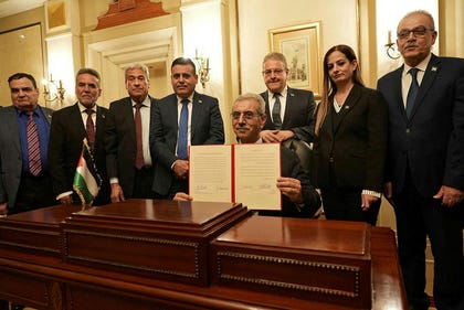 A handout photograph released by Egypt's State Information Service shows Ali Shaath (C), head of the new Palestinian technocratic committee for administering the Gaza Strip, posing with its members during the inaugural meeting of 'National Committee for the Administration of Gaza' (NCAG), in Cairo on Sunday.