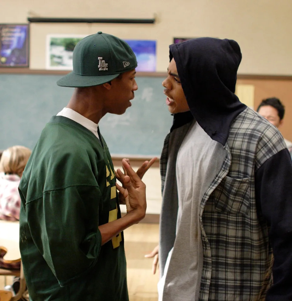 Deance Wyatt and Mario facing each other, arguing in a classroom in "Freedom Writers"