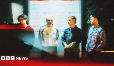 Prime Minister Mark Carney, wearing a black suit jacket, and a white button-up shirt leans his chin on his hands. He has short grey and black hair and is looking away from the camera.
