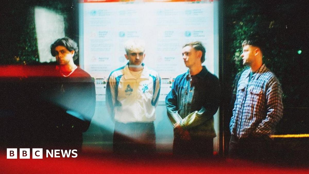 Prime Minister Mark Carney, wearing a black suit jacket, and a white button-up shirt leans his chin on his hands. He has short grey and black hair and is looking away from the camera.